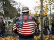 Navy veteran Roger Moody, of Vancouver, watches the annual Lough Legacy Veterans Parade at Fort Vancouver in November 2017. More than 100 organizations marched in parade.