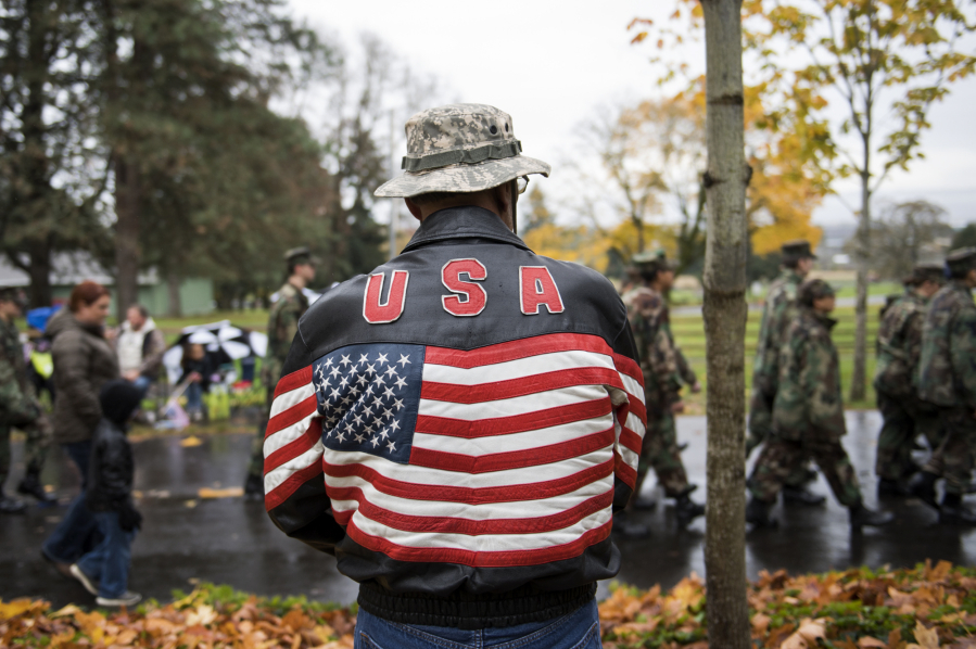 Navy veteran Roger Moody, of Vancouver, watches the annual Lough Legacy Veterans Parade at Fort Vancouver in November 2017. More than 100 organizations marched in parade.