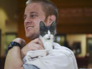 After getting a health check and spending some time with a foster family and getting vaccinations, Chai, a male kitten, is ready for adoption. Sean Dinsmore, a volunteer at the Humane Society for Southwest Washington, gives him a break from his kennel.