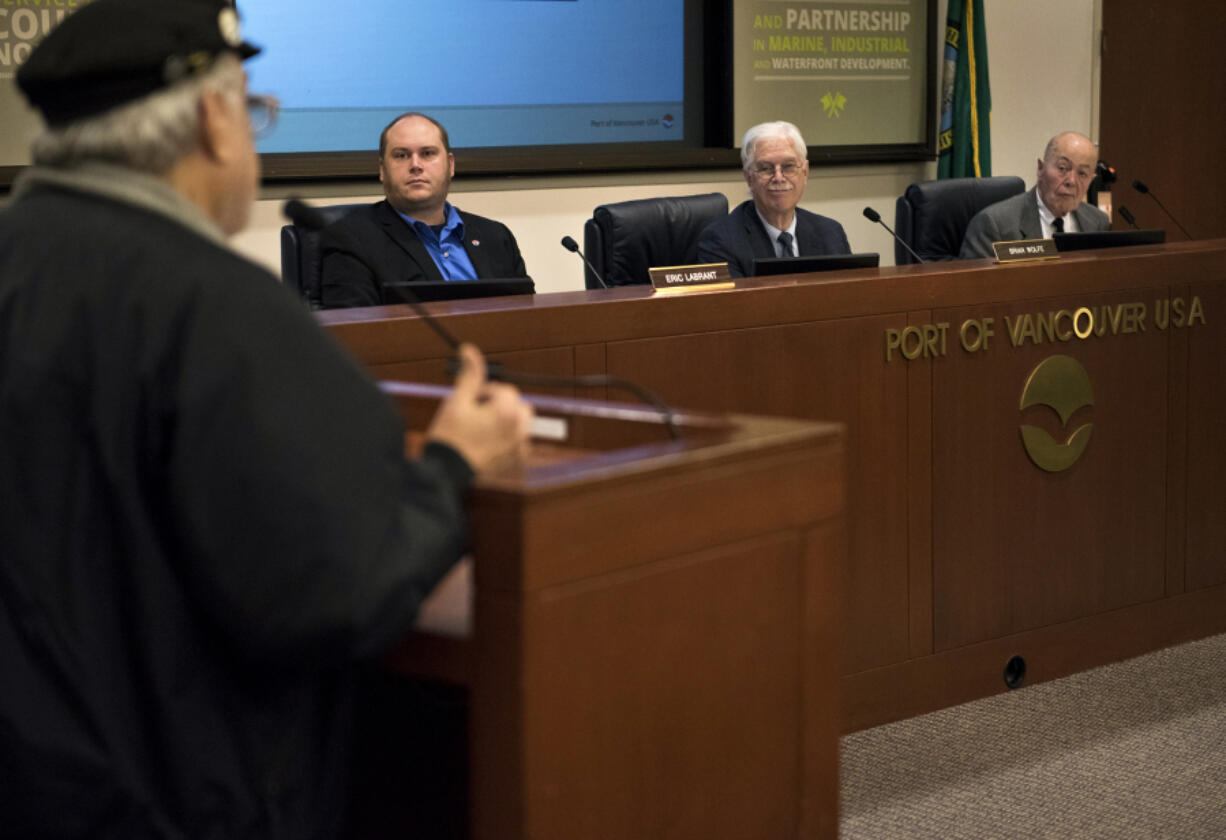 Jim Eversaul, a Vancouver resident and retired U.S. Coast Guard chief engineer, speaks Tuesday to the board of commissioners Eric LaBrant, Brian Wolfe and Jerry Oliver during the public forum at a Port of Vancouver board meeting. A large crowd showed up to voice support of not extending the lease for a proposed oil terminal at the port, something newly elected commissioner, Don Orange, has said he would do.