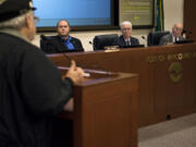 Jim Eversaul, a Vancouver resident and retired U.S. Coast Guard chief engineer, speaks Tuesday to the board of commissioners Eric LaBrant, Brian Wolfe and Jerry Oliver during the public forum at a Port of Vancouver board meeting. A large crowd showed up to voice support of not extending the lease for a proposed oil terminal at the port, something newly elected commissioner, Don Orange, has said he would do.