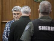 Brent Luyster prepares to be seated during his triple aggravated murder trial in Clark County Superior Court on Monday morning, Nov. 13, 2017.