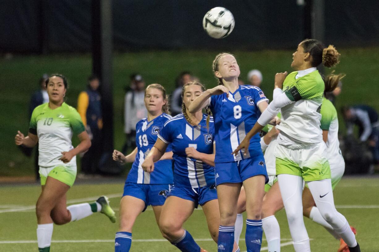 Penguin's Rylee MacDonald (8) leaps for a header during their semi-finals game against Highline College at Starfire Field in Tukwila, WA, on Nov. 10, 2017. The Thunderbirds beat the Penguins by one penalty kick after going 2-2 in double overtime.