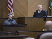 Brent Luyster, left, takes the stand during his triple aggravated murder trial as Judge Robert Lewis listens in Clark County Superior Court on Tuesday morning.