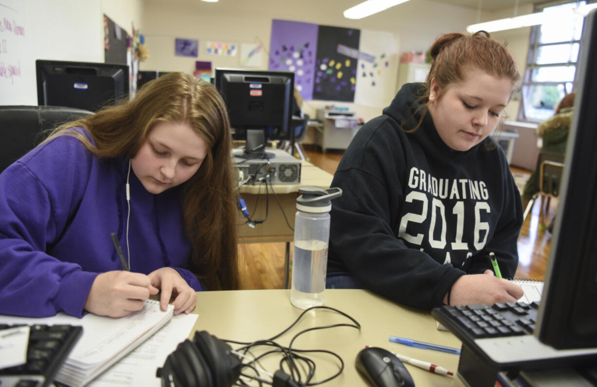 Chelseanne LaRue, 18, left, works on a math assignment next to her sister, Richland LaRue, 19, during their Open Doors Reengagement Program class, a re-entry program for students working to obtain their diploma after dropping out of high school. The sisters dropped out of school about two years ago after their family was homeless.