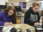 Chelseanne LaRue, 18, left, works on a math assignment next to her sister, Richland LaRue, 19, during their Open Doors Reengagement Program class, a re-entry program for students working to obtain their diploma after dropping out of high school. The sisters dropped out of school about two years ago after their family was homeless.