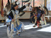 Dancers, including Louis Kameroff, left, and Phillip Montana, perform Saturday at the Heritage Festival at the Water Resources Education Center in Vancouver.