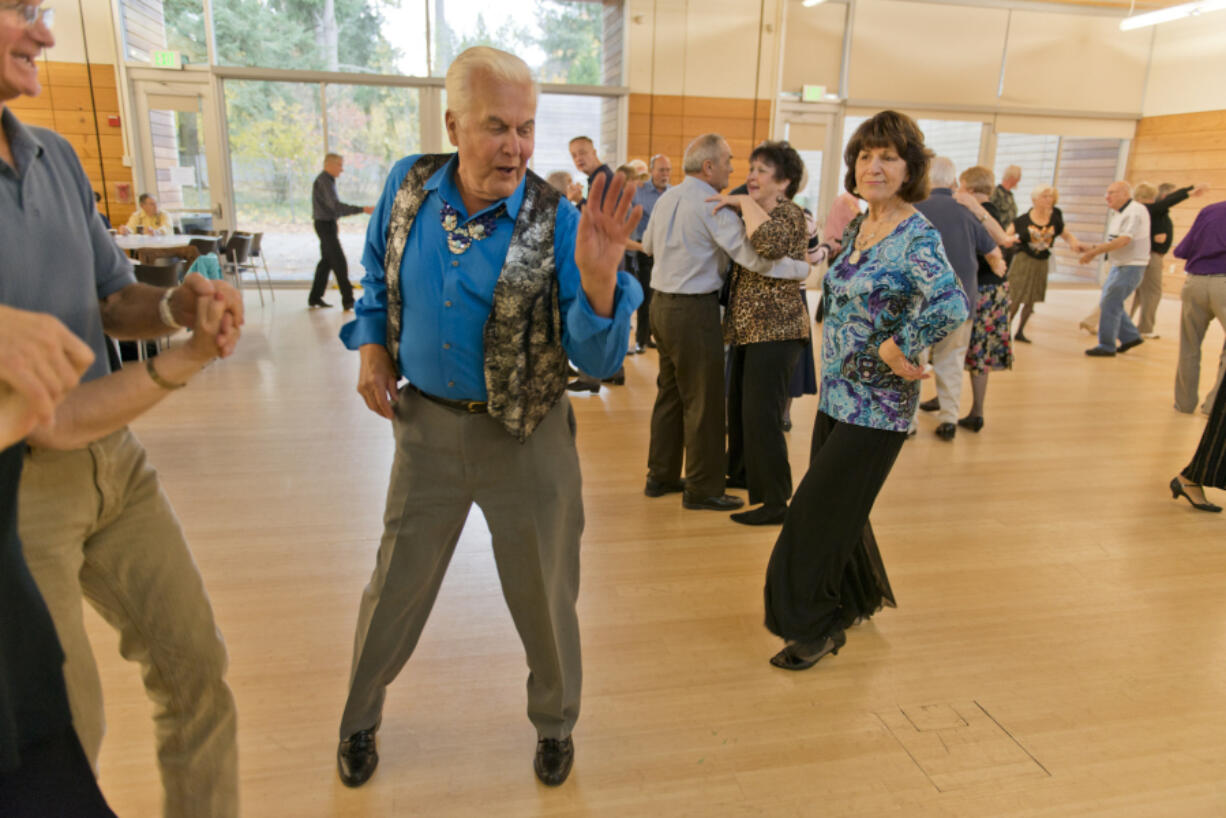 Mark Melchert and Judy Bealer dance at one of the city parks and recreation department’s regular 50 and Better dances Sunday at the Firstenburg Community Center.