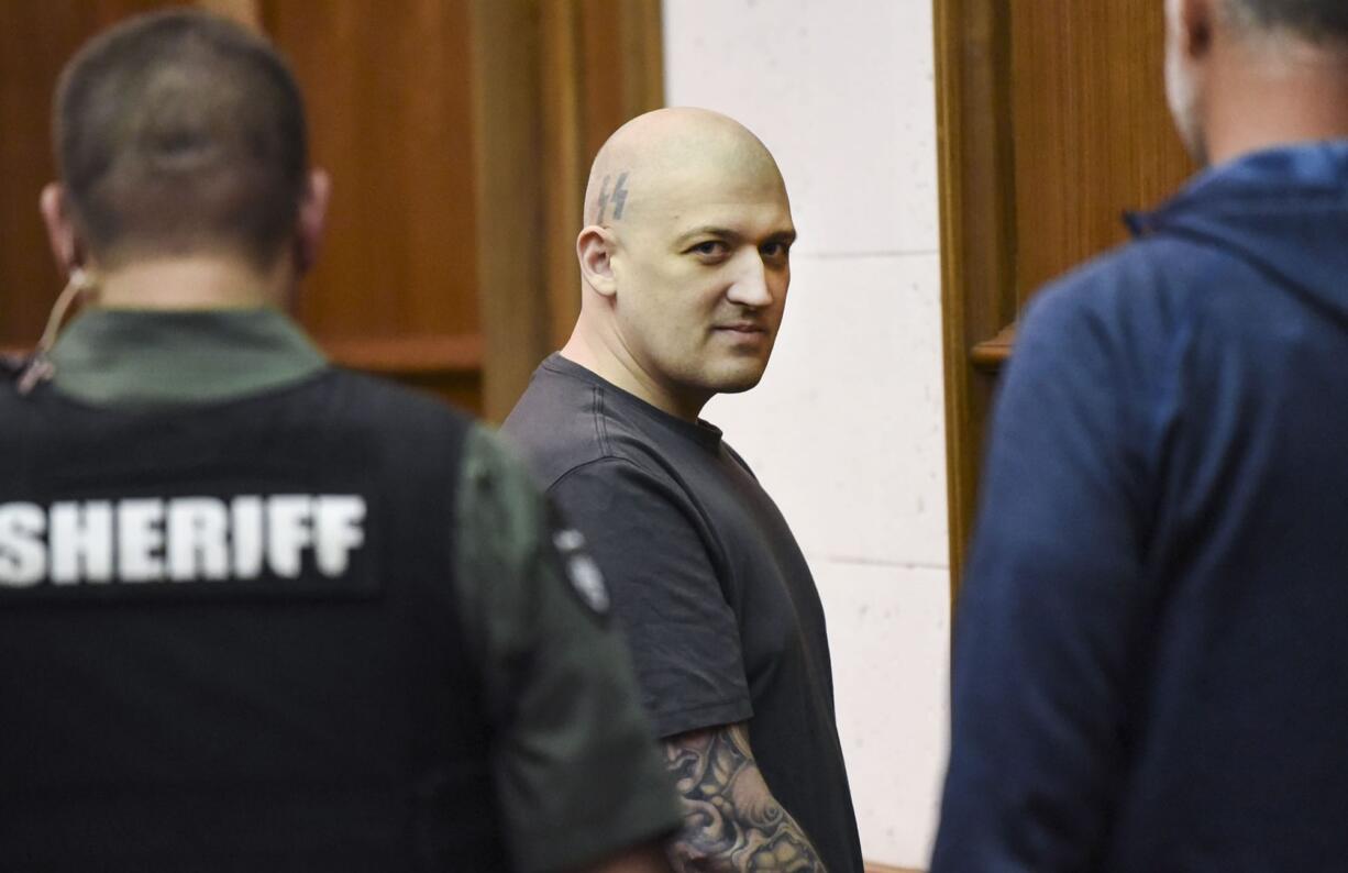 Brent Luyster leaves the courtroom after the judge answered a question from the jury, during his triple aggravated murder trial in Clark County Superior Court, Thursday evening.