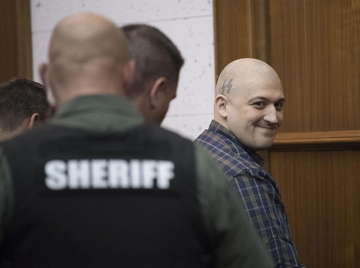 Brent Luyster reacts after being found guilty on all counts in his triple aggravated murder trial in Clark County Superior Court on Friday morning, Nov. 17, 2017.