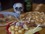 The Rick Reuben, foreground, with a Stromboli stuffed with pepperoni and Italian sausage, background left, and the Southern Fried BBQ pizza at Heavy Metal Brewing Co.