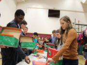 Battle Ground: Elementary through high school students at Firm Foundation Christian School spent part of their Halloween packing boxes full of supplies for children overseas.