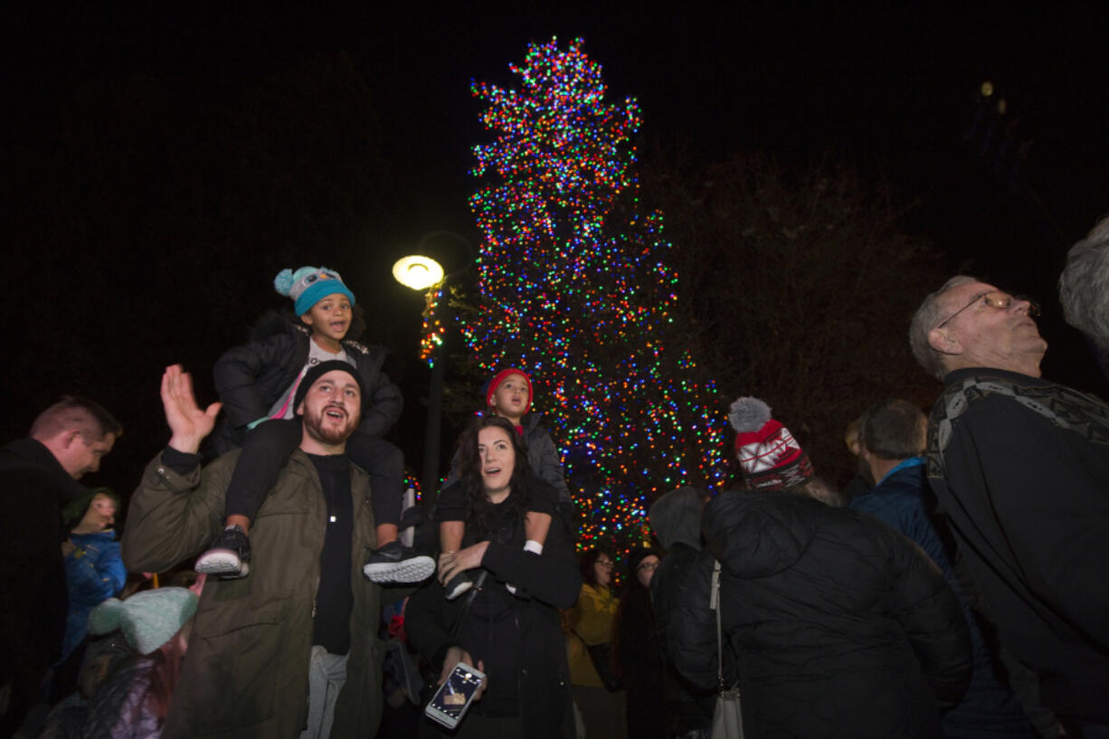 Vancouver’s community Christmas tree lights up the night in Esther Short Park as hundreds of people take part Friday in the annual celebration.