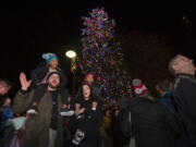 Vancouver’s community Christmas tree lights up the night in Esther Short Park as hundreds of people take part Friday in the annual celebration.