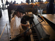 David Allen Welsh, currently homeless in Vancouver, plays the piano during the free Thanksgiving meal, hosted by state Court of Appeals Judge Rich Melnick, Chuck Chronis and Mark Matthias at WareHouse’ 23 in Vancouver on Thursday. Welsh played one of several songs he said he’s created in his mind.