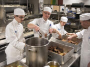 Culinary students Daniel Templin of Woodland, left, Aaron Welton of Battle Ground, Arryn Sayer of Castle Rock, and William Hobson of Vancouver, prepare chicken stock during their morning class at Clark College’s Tod and Maxine McClaskey Culinary Institute in Vancouver on Tuesday.