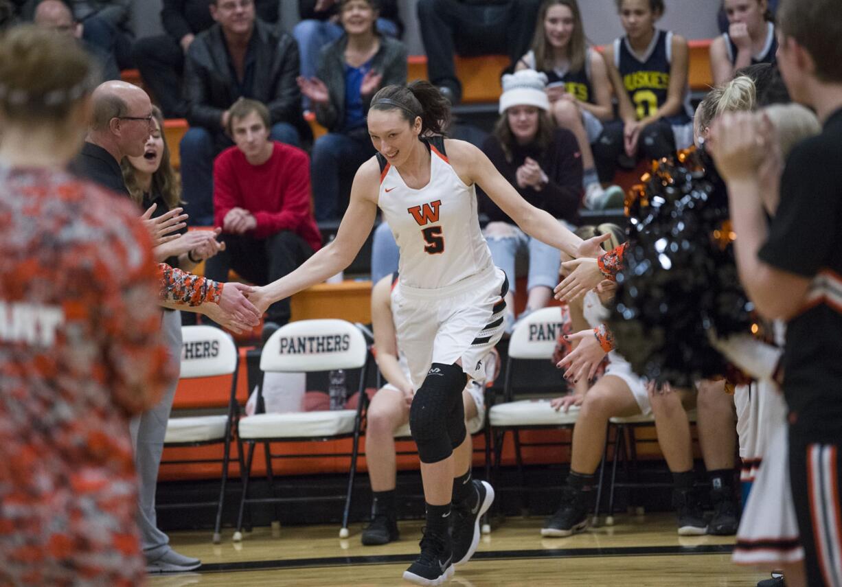 Washougal’s Beyonce Bea high-fives her teammates before the first game of the season against Evergreen High School at Washougal High School, Monday November 27, 2017.