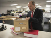 Clark County Auditor Greg Kimsey opens a box containing archives of voter registration forms at the Clark County Elections Office. Kimsey’s office handles paperwork for voter registration, which is now becoming increasingly political.