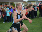 Daniel Maton of Camas, right, and Ryan Kline of Central Valley in Spokane, fight to the finish line. Maton tumbled and Kline captured the 4A boys state cross country championship in 15 minutes, 11 seconds on Saturday, Nov. 5, 2017, at Pasco.