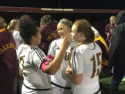 Prairie soccer players, from left, Malaika Quigley, Kaylin Sperley and Sydney Weber celebrate a 2-1 win over Marysville-Getchell in the Class 3A state playoffs on Wednesday in Brush Prairie.