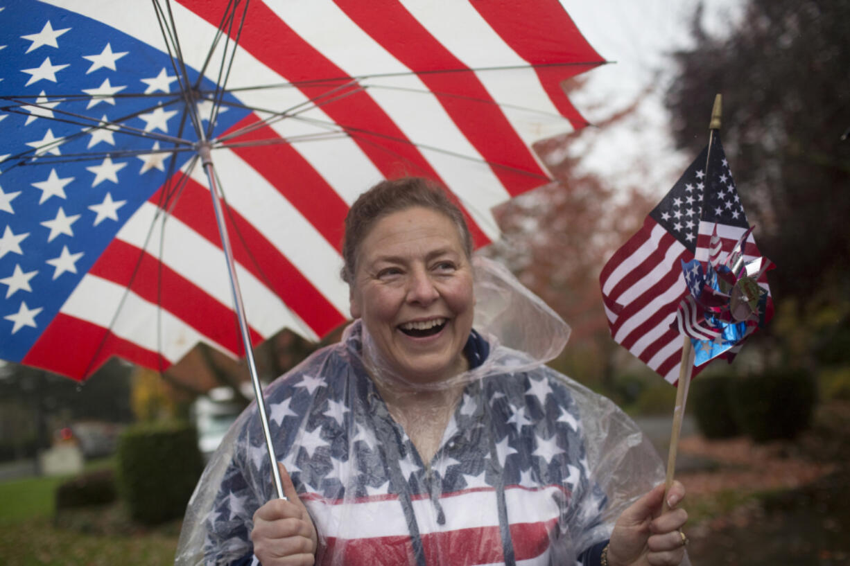 Lori Homola is decked out in American flags as she watches the Veterans Parade at Fort Vancouver on Nov. 5, 2016.