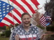 Lori Homola is decked out in American flags as she watches the Veterans Parade at Fort Vancouver on Nov. 5, 2016.