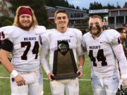 Central Washington's Clark County football players Will Ortner (Hockinson HS), Reilly Hennessey (Camas), and Kevin Haynes (Battle Ground) with the GNAC trophy after the Wildcats beat Humboldt State 42-28 on Saturday, Nov. 11, 2017, at Arcata, Calif., to wrap up an 11-0 regular season.