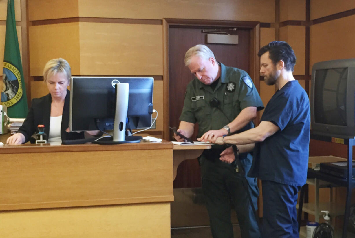 Clean energy entrepreneur John Garrett Smith is fingerprinted in Clark County Superior Court after being sentenced to 144 months in prison for the attempted murder of his wife. The Washington Supreme Court on Tuesday reversed an appeals court’s decision that had overturned Smith’s attempted murder conviction.