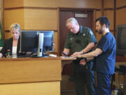 Clean energy entrepreneur John Garrett Smith is fingerprinted in Clark County Superior Court after being sentenced to 144 months in prison for the attempted murder of his wife. The Washington Supreme Court on Tuesday reversed an appeals court’s decision that had overturned Smith’s attempted murder conviction.