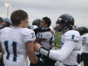 The Hockinson Hawks, including Kordell Johnson (53) and Canon Racanelli celebrate the team's 53-30 victory Saturday over West Valley of Spokane.