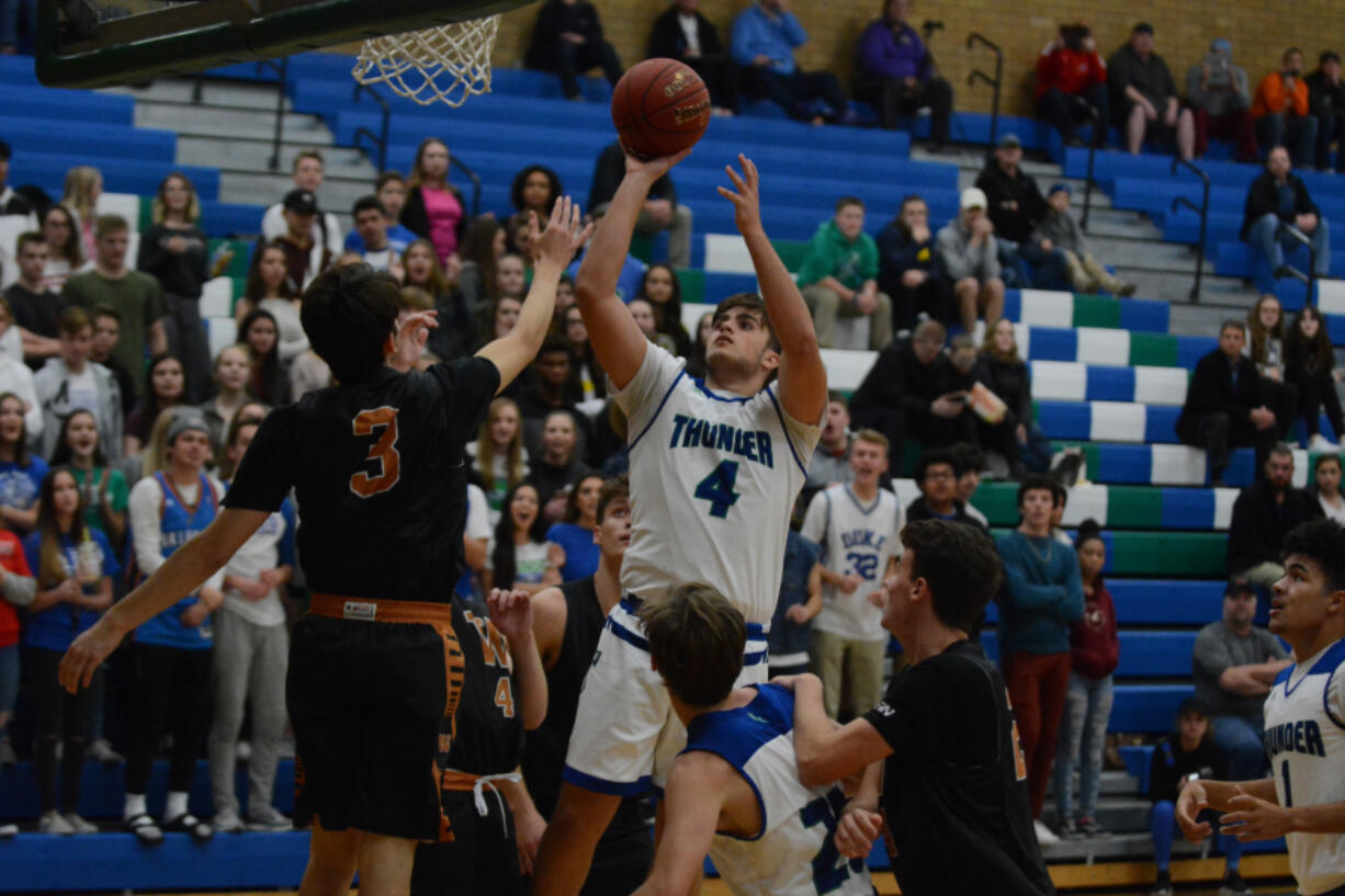 Mountain View’s Alex Hegel (4) scores against Washougal on Monday at Mountain View High School. Hegel scored 22 points to lead the Thunder to a 77-72 season-opening win.