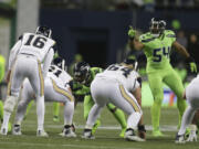 Seattle Seahawks Bobby Wagner (54) is making a case to become only the third middle linebacker since 2003 to win the NFL’s defensive player of the year award.