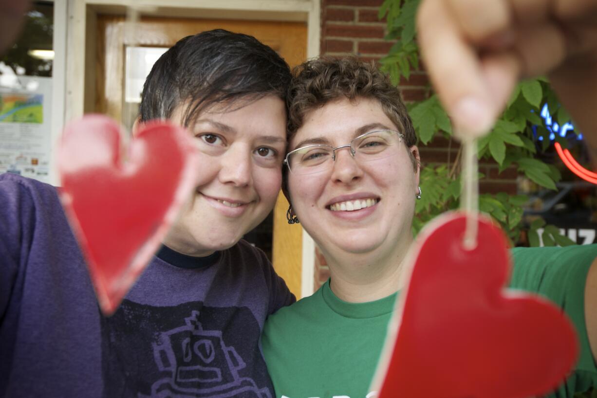 Same-sex marriage advocates Kelly Keigwin, left, and Sam MacKenzie hold "heart bombs" for a "love is radical" campaign in September 2012 in Vancouver to encourage people to vote to approve Referendum 74. The ballot measure to allow same-sex couples in Washington to get married was approved by voters, and the law went into effect Dec. 6, 2012. The first same-sex marriages in the state took place three days later.