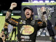 Martin Truex Jr. celebrates in Victory Lane after winning the NASCAR Cup Series auto race and season championship at Homestead-Miami Speedway in Homestead, Fla., Sunday, Nov. 19, 2017.