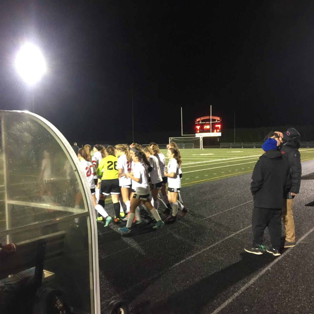 The Camas girls soccer team gathers around Perrin Belzer, who was injured late in Camas' win over Skyline.