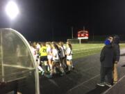 The Camas girls soccer team gathers around Perrin Belzer, who was injured late in Camas' win over Skyline.