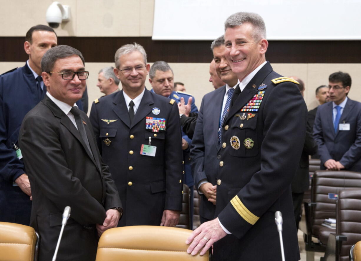 Afghanistan’s acting defense minister Major General Tariq Shah Bahrami, second left, poses for a photo with the US top commander in Afghanistan US Army General John Nicholson, right, during a round table of NATO defense ministers and Resolute Support operational partner nations at NATO headquarters in Brussels on Thursday, Nov. 9, 2017.