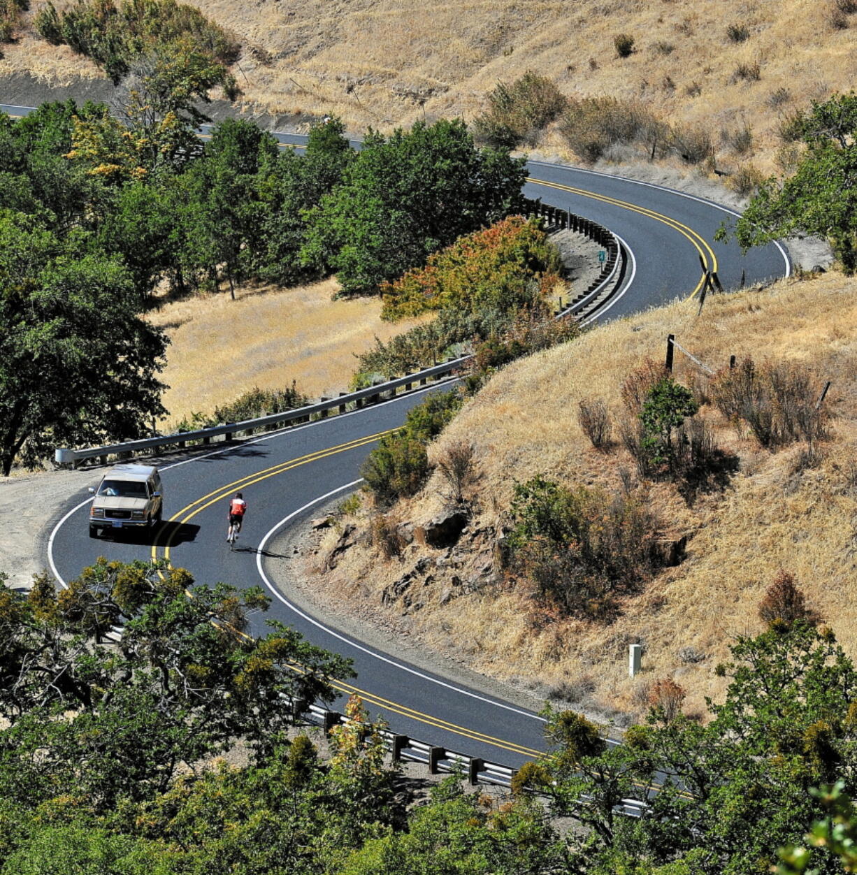 A bicyclist rides down Dead Indian Memorial Road near Ashland, Ore. Commissioners in Oregon’s Jackson County decided not to change the name of Dead Indian Memorial Road even though the name remains controversial.