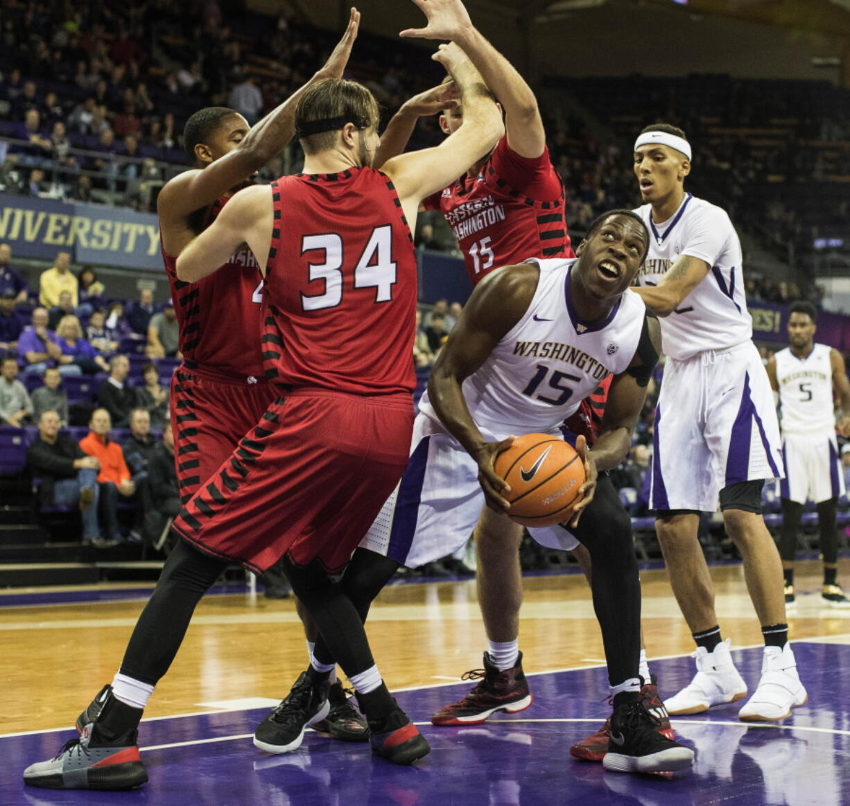 Washington’s Noah Dickerson steps out of the triple team in the low post and puts up a shot during Saturday’s game against Eastern Washington.