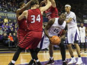 Washington’s Noah Dickerson steps out of the triple team in the low post and puts up a shot during Saturday’s game against Eastern Washington.