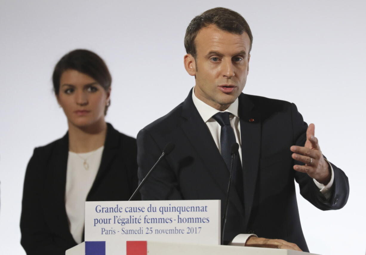 French President Emmanuel Macron delivers his speech as French Junior Minister for Gender Equality Marlene Schiappa, left, listens, during a ceremony marking the International Day for the Elimination of Violence Against Women, Saturday Nov. 25, 2017 at the Elysee Palace in Paris.