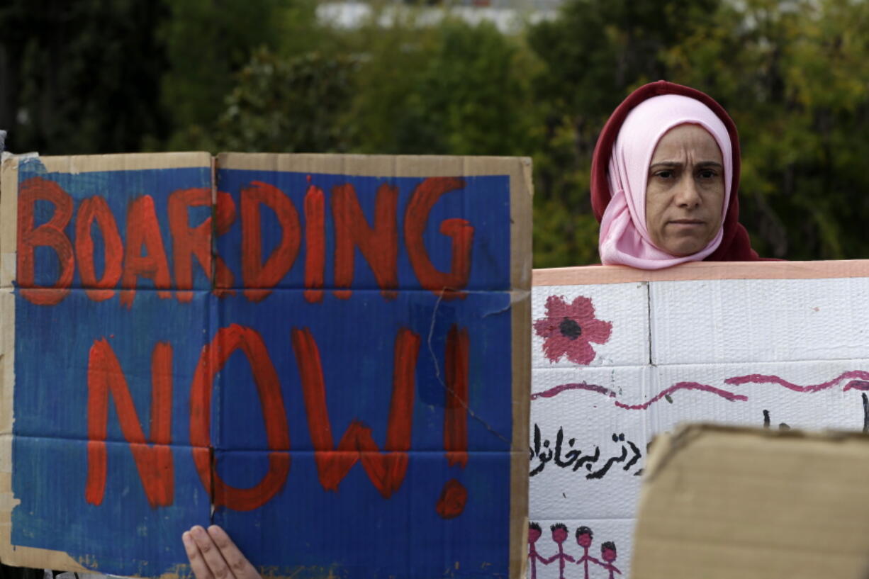 Stranded migrants and refugees demonstrate during a rally in Athens on Wednesday. A few dozens people, among them young children, protested against delays in reuniting with their relatives in Germany as some of them will start hunger strike in front of the Greek Parliament.