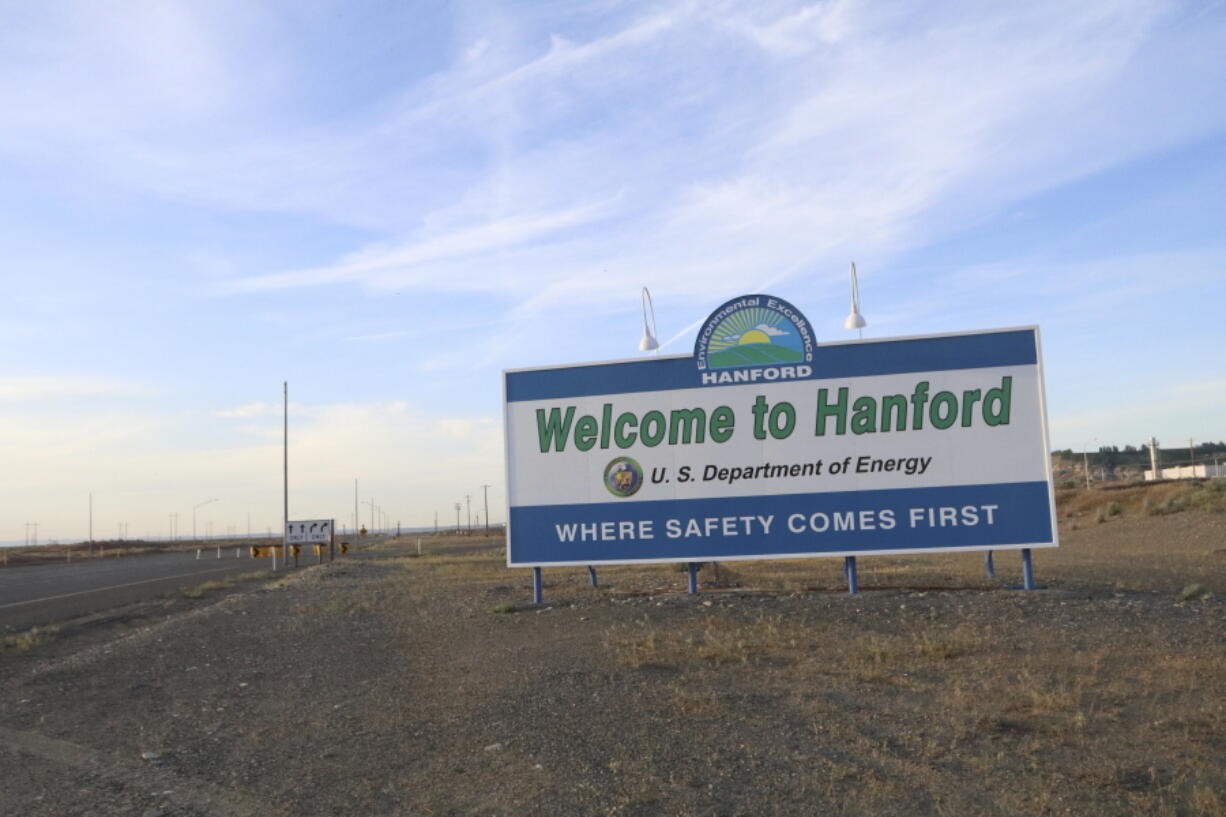 FILE - In this May 9, 2017 file photo, a sign welcomes drivers to Hanford Nuclear Reservation in Richland, Wash. After almost two decades of work, the government has nearly finished removing radioactive wastes from a first group of underground storage tanks in eastern Washington.