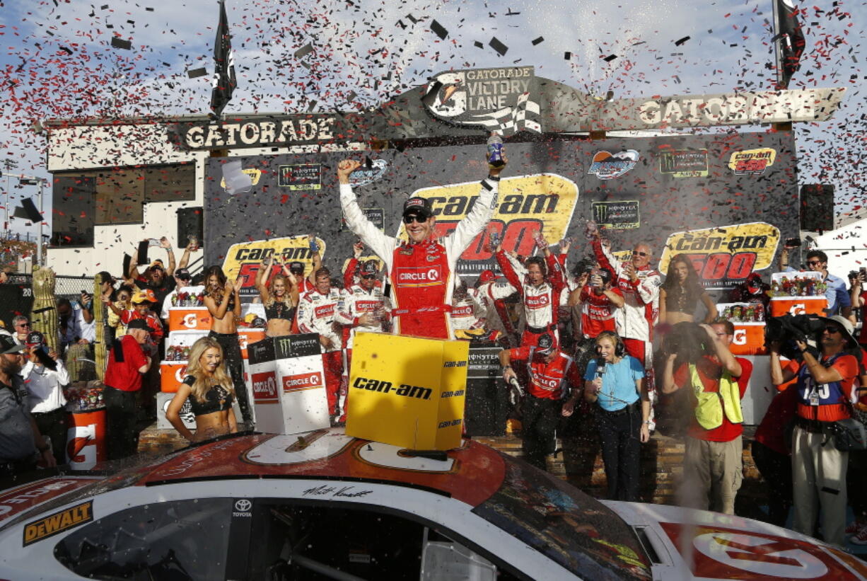 Matt Kenseth celebrates his win in Victory Lane after a NASCAR Cup Series auto race at Phoenix International Raceway Sunday, Nov. 12, 2017, in Avondale, Ariz. (AP Photo/Ross D.