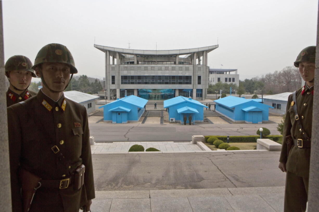 North Korean soldiers stand on steps overlooking the border village of Panmunjom, North Korea, which has separated the two Koreas since the Korean War. South Korea said on Monday, Nov. 13, 2017, that North Korean soldiers shot at and injured a fellow soldier who was crossing the border village to try to defect to the South. South Korea’s Joint Chiefs of Staff said the injured North Korean was being taken to a hospital after crossing the border village of Panmunjom. Defections are rare by that route.