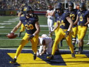 California’s Patrick Laird, left, celebrates after scoring a touchdown against Oregon State during the first half of an NCAA college football game Saturday, Nov. 4, 2017, in Berkeley, Calif.