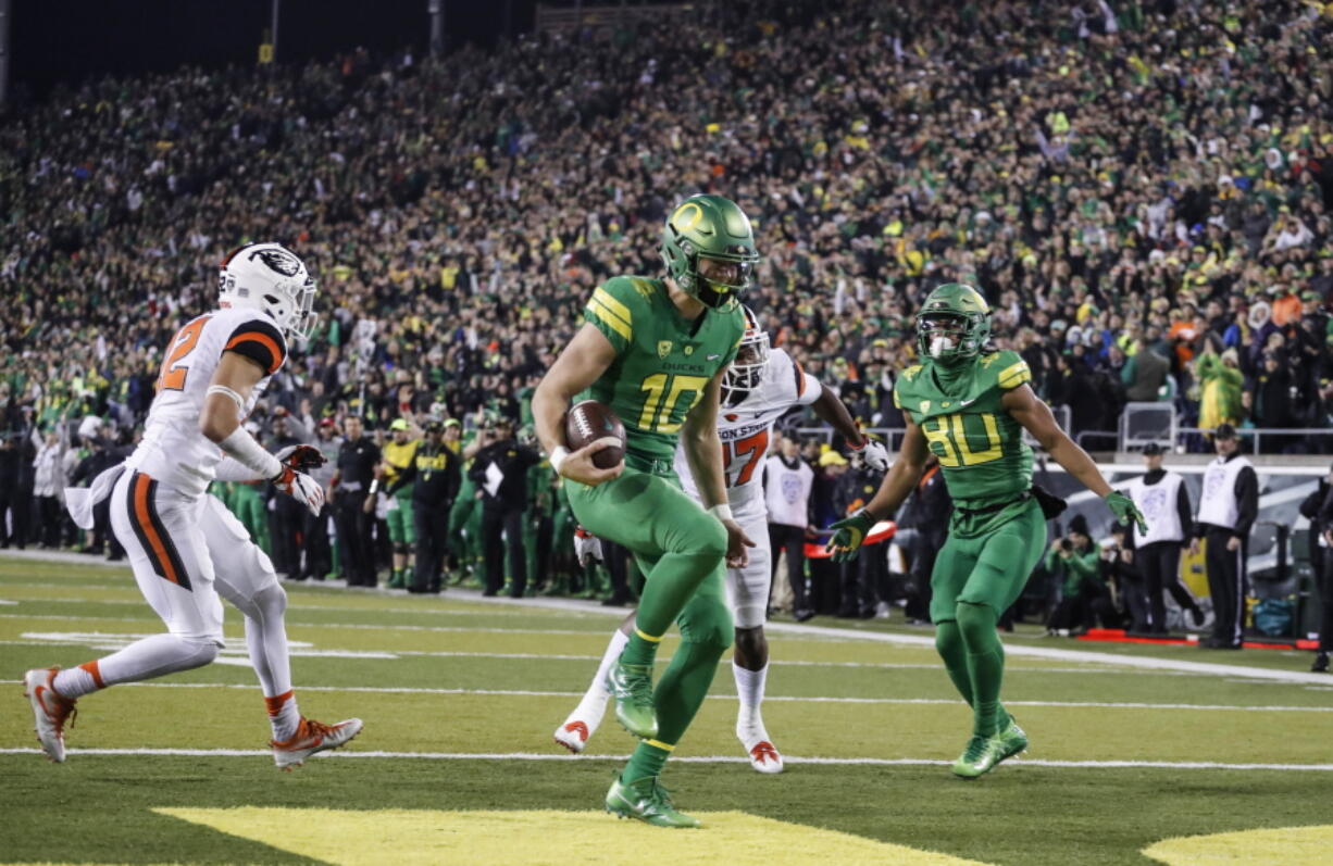 Oregon quarterback Justin Herbert (10), scores a touchdown untouched in the second quarter against Oregon State in an NCAA college football game Saturday, Nov. 25, 2017 in Eugene, Ore.