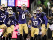 Washington’s Dante Pettis celebrates with teammates after his 64-yard punt-return touchdown against Oregon in the first half of an NCAA college football game in Seattle on Saturday, Nov. 4, 2017. Pettis broke the NCAA record for punt returns for touchdowns with nine, after taking a punt back 64 yards for the score in the second quarter on Saturday.