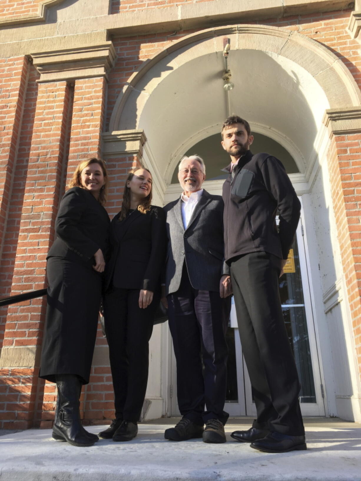 This Nov. 21, 2017, photo provided by the Climate Direct Action group shows Leonard Higgins, second from right, with his defense attorneys outside the Choteau County Courthouse in Fort Benton, Mont. Higgins was convicted Wednesday, Nov. 22, on charges of of criminal mischief and trespassing after he entered a fenced site near Big Sandy, Mont., in October 2016 and closed a valve on a pipeline carrying crude oil from Canada to the United States to call attention to climate change. With Higgins are attorney Lauren Regan, left; attorney Kelsey Skaggs, second from left, and attorney Herman Watson.