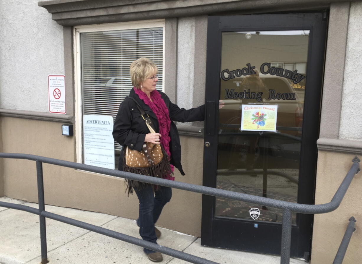 A woman enters the meeting hall of the Crook County commissioners on Wednesday, Nov. 8, 2017 in Prineville, Ore. Commissioners unanimously adopted a land-use plan that says the county will participate fully in planning and decisions on federal lands that comprise about half of the county in central Oregon.